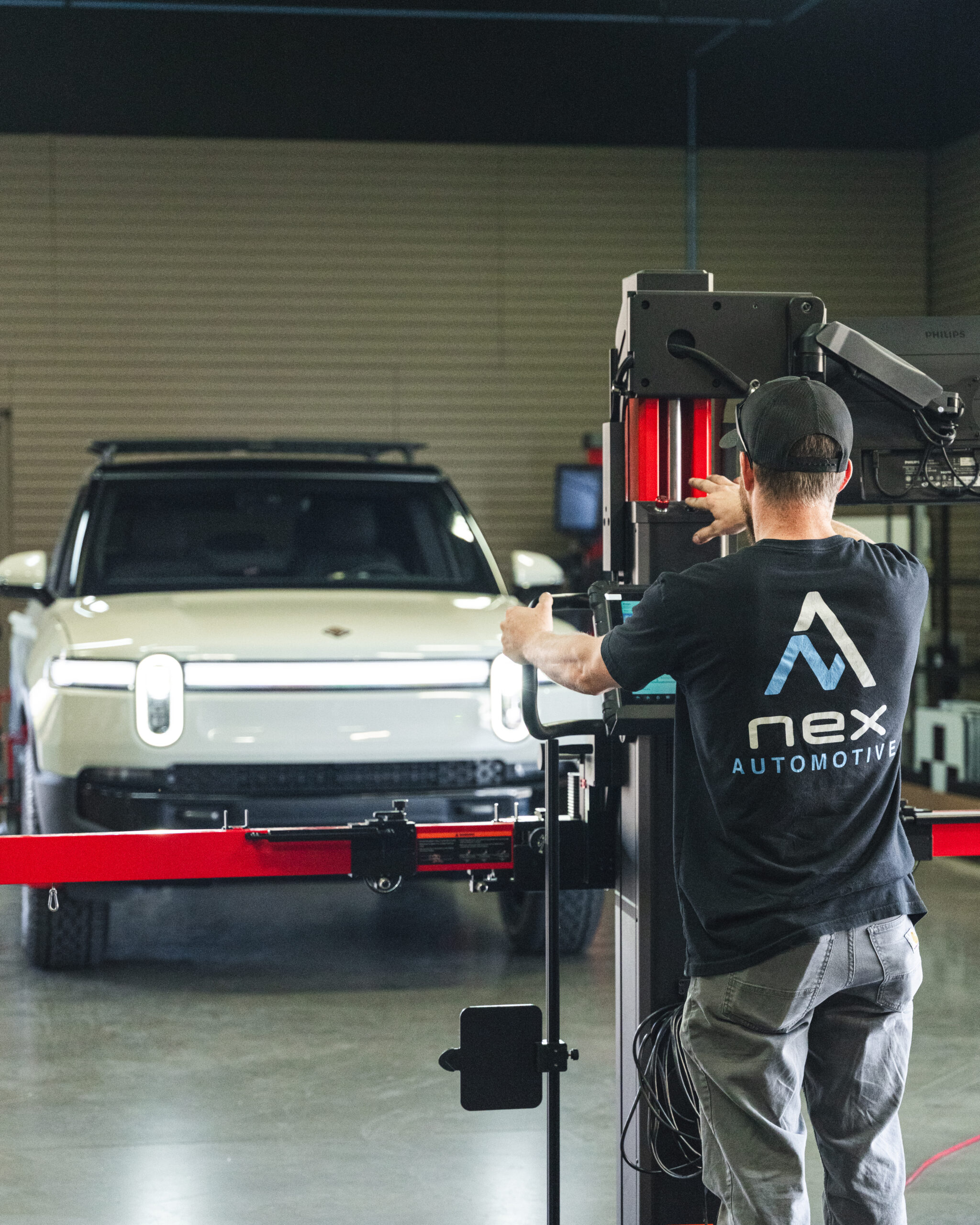 rivian_adas-calibration-oem-compliant-rocklin Technician performing ADAS calibration on vehicle in Rocklin, CA